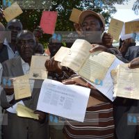 Kenya Air Force ex-servicemen display their discharge certificates