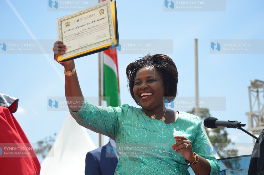 Joyce Laboso holds up her inauguration certificate