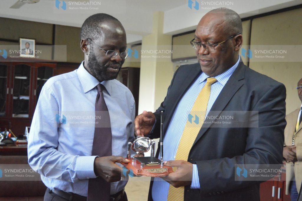 Stephen Gitagama hands a gift to Kisumu Governor Anyang’ Nyong’o