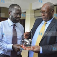 Stephen Gitagama hands a gift to Kisumu Governor Anyang’ Nyong’o