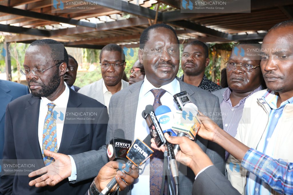 Raila Odinga (center), address the press