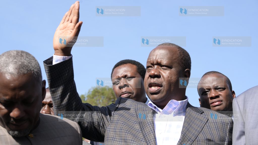 Fred Matiang'i gestures after leaving DCI headquarters