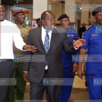 Fred Matiang'i flanked by (left) Nairobi Senator Johnson Sakaja and (right) Inspector General of Police