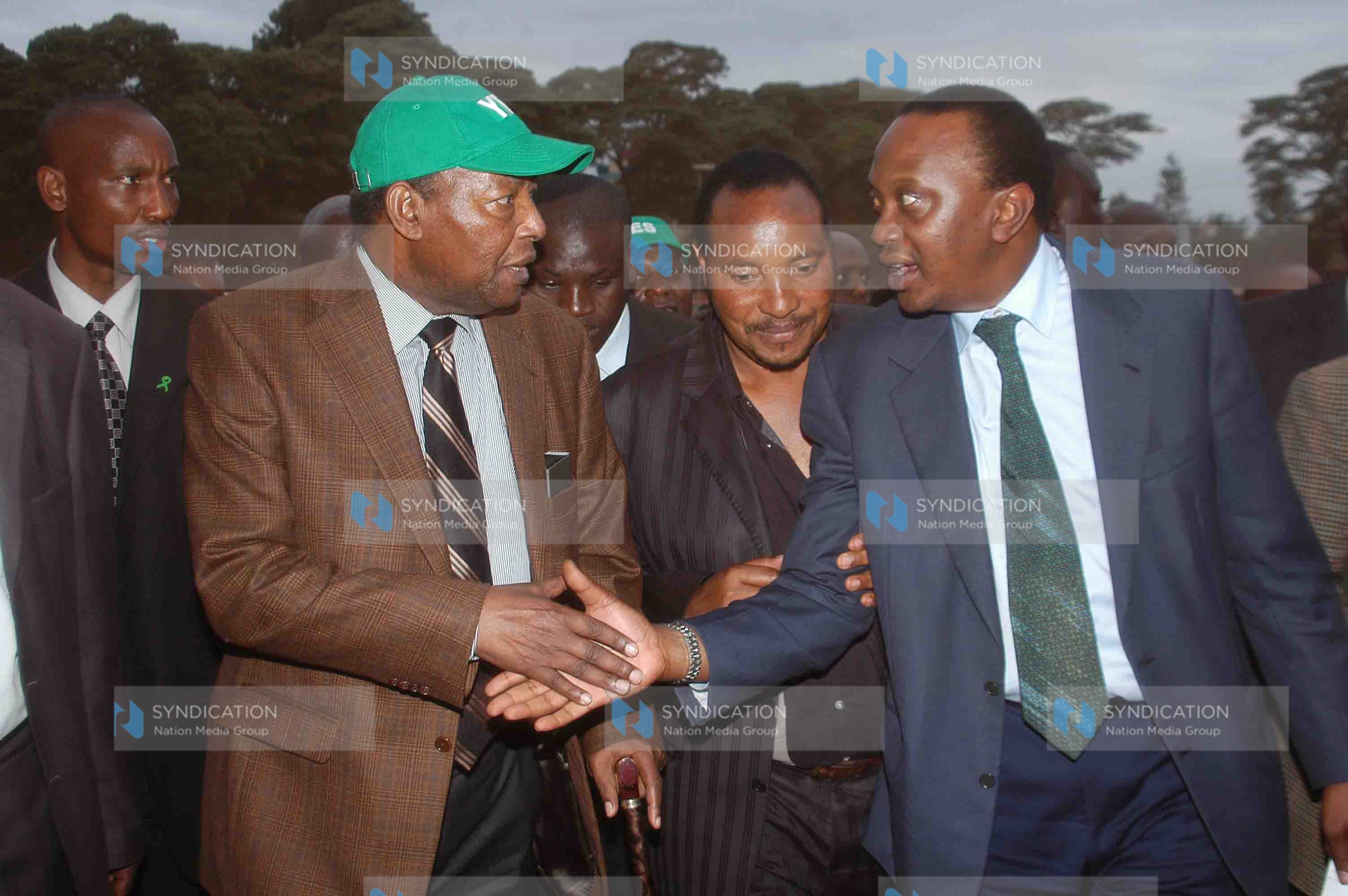 Deputy prime minister Uhuru Kenyatta, right, shakes hands with environment minister