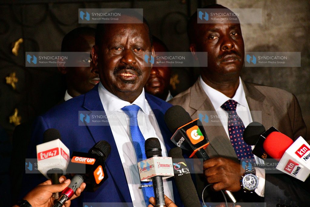 Raila Odinga (left) addressing media