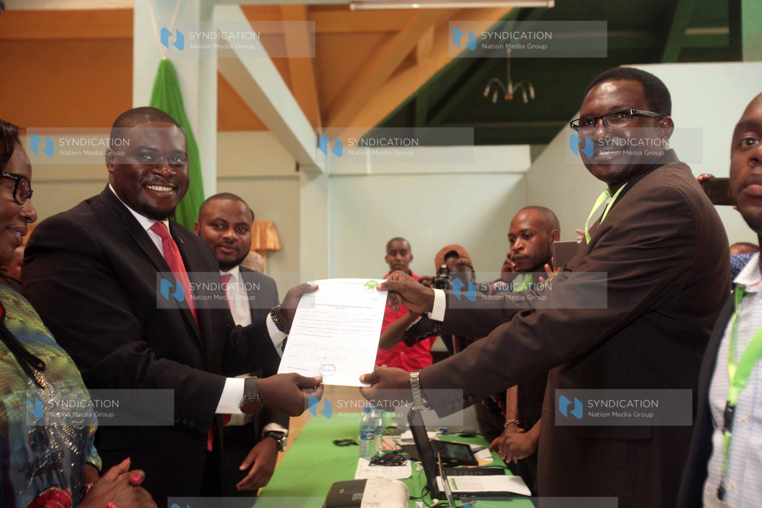 Nairobi Senatorial Aspirant on Jubilee ticket Johnson Sakaja receiving clearance certificate from the IEBC Nairobi County returning officer Joseph Eroo