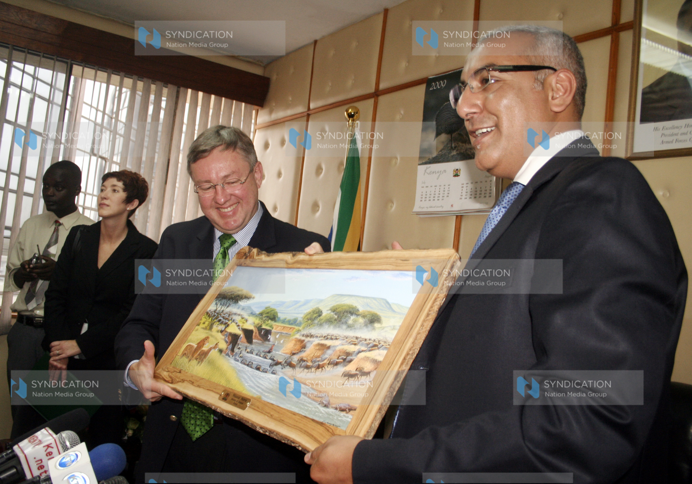 Minister for Tourism Najib Balala present a gift of art drawing showing migration of world beasts to his counterpart from South Africa, Marthinus van Schalkwyk