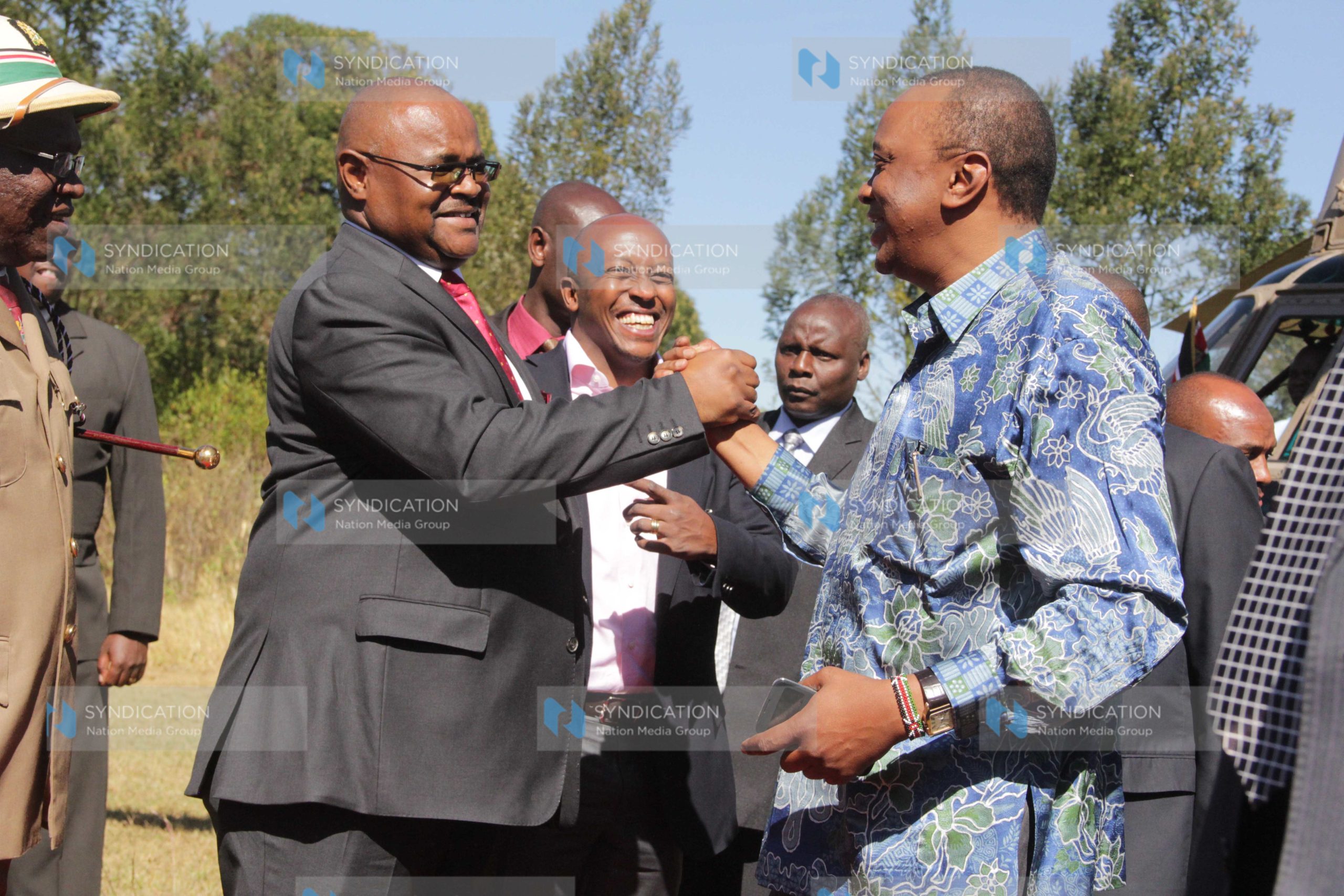 President Uhuru Kenyatta greets Kenya Pipeline chairman Daniel Wamahiu