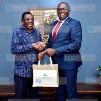 Nation Media Group (NMG) Group Managing Director and CEO Geoffrey Odundo presents a gift to Siaya Governor James Orengo