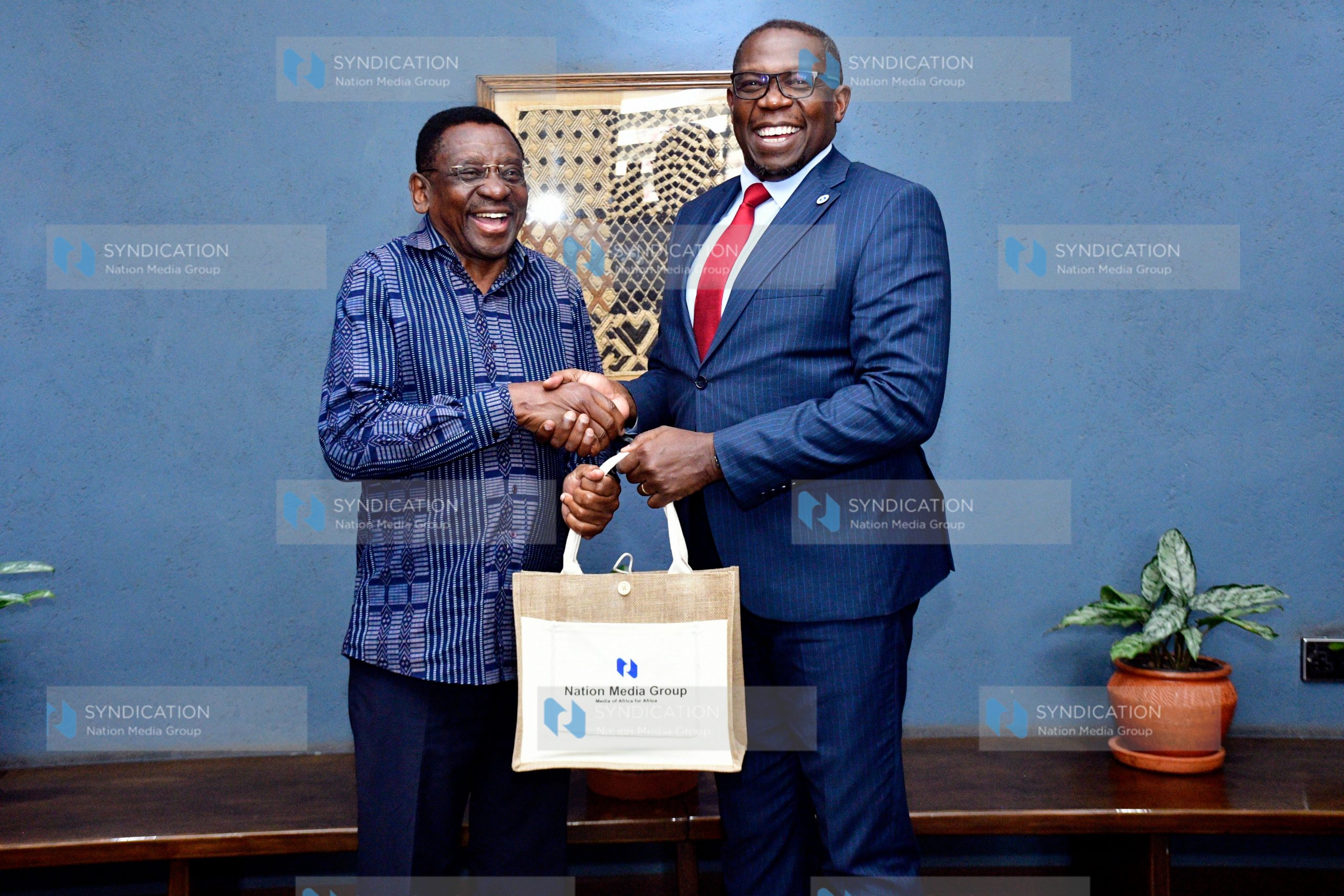 Nation Media Group (NMG) Group Managing Director and CEO Geoffrey Odundo presents a gift to Siaya Governor James Orengo