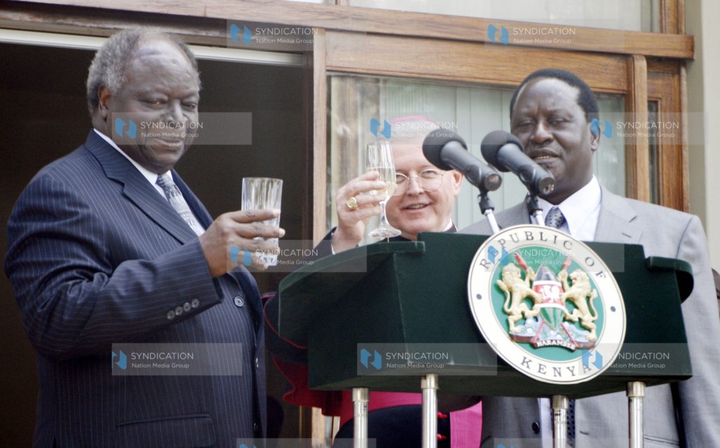 President Mwai Kibaki (left) is joined by Prime minister Raila Odinga (right)