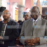 Former President Mwai Kibaki (Right) joins Catholic faithful