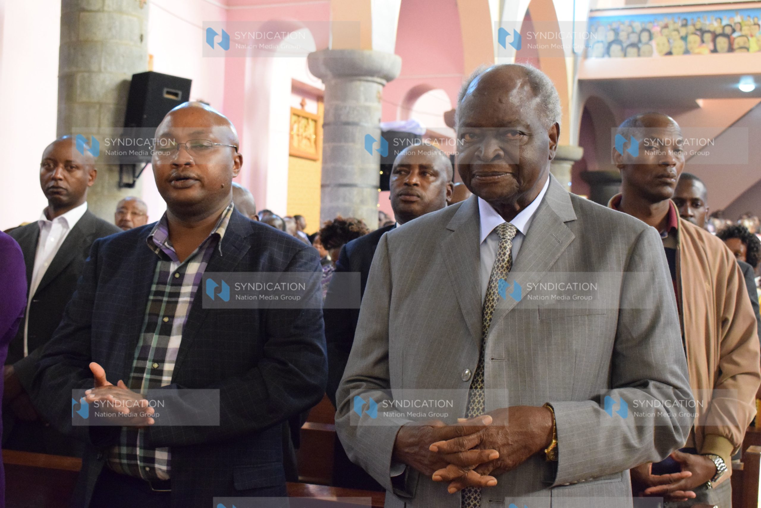 Former President Mwai Kibaki (Right) joins Catholic faithful