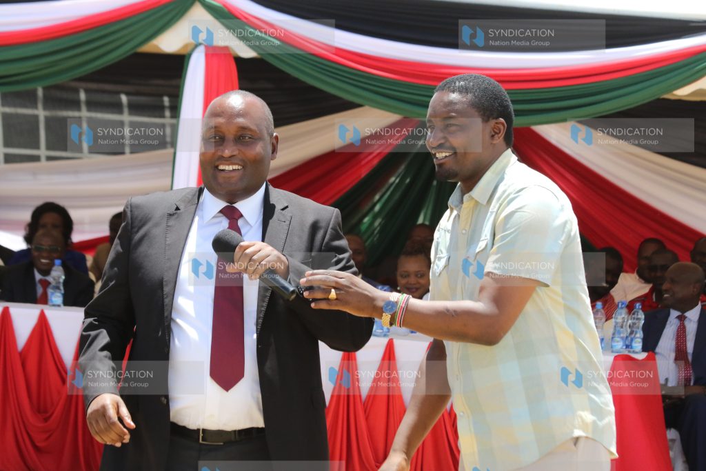Devolution CS Mwangi Kiunjuri hands over a microphone