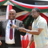 Devolution CS Mwangi Kiunjuri hands over a microphone