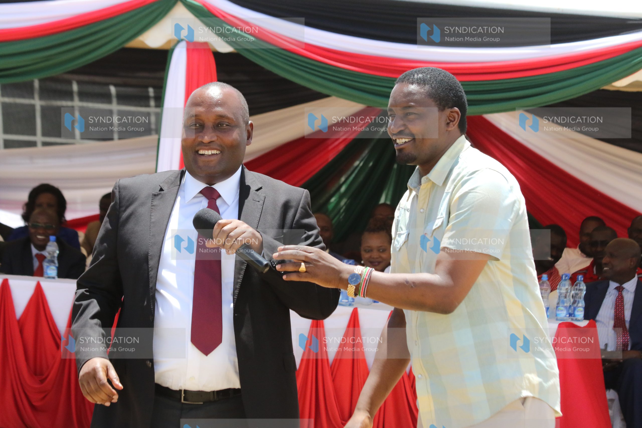 Devolution CS Mwangi Kiunjuri hands over a microphone