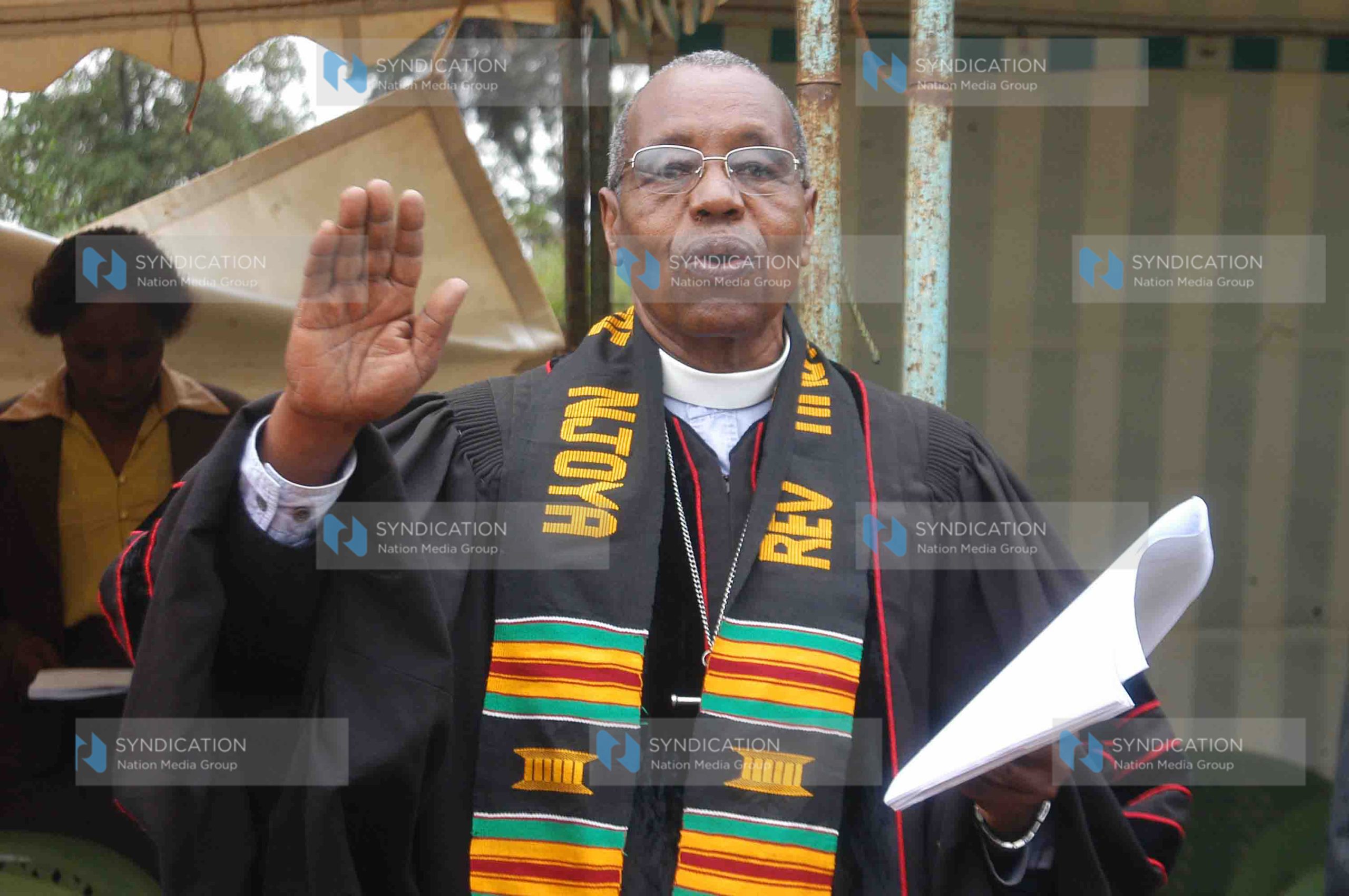 Retired clergy Timothy Njoya sings a hymn