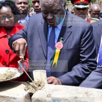President Mwai Kibaki places a foundation stone
