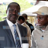 Ababu Namwamba confers with Raila Odinga