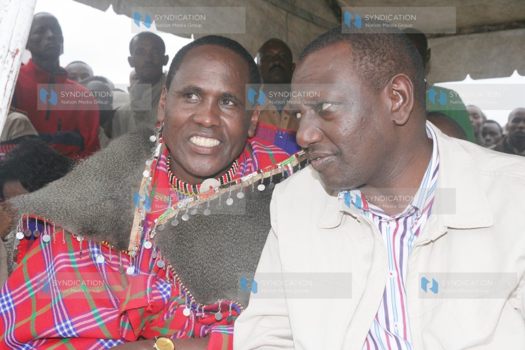 Agriculture Minister William Ruto confers with politician Martine Ole Kamwaro
