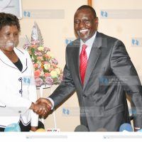 Suspended Higher Education Minister William Ruto shakes hands with Hellen Sambili