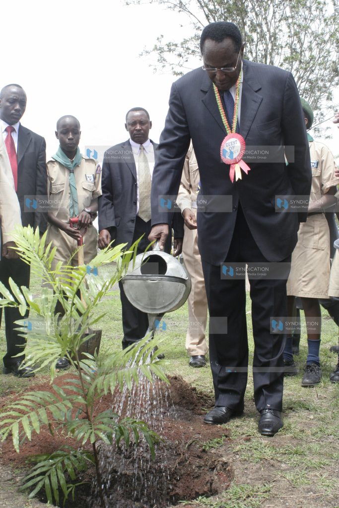 Minister of State Provincial Administration and Internal Security George Saitoti waters a plant