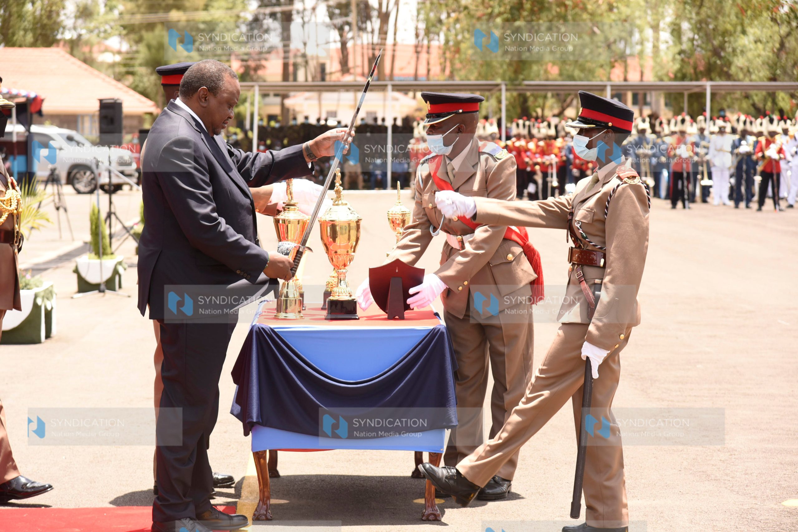 President Uhuru Kenyatta awards Mary Wanjiku Nduati for being the Best Officer Cadet in Leadership and Command