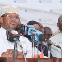 Hassan Omar (centre) addresses the press