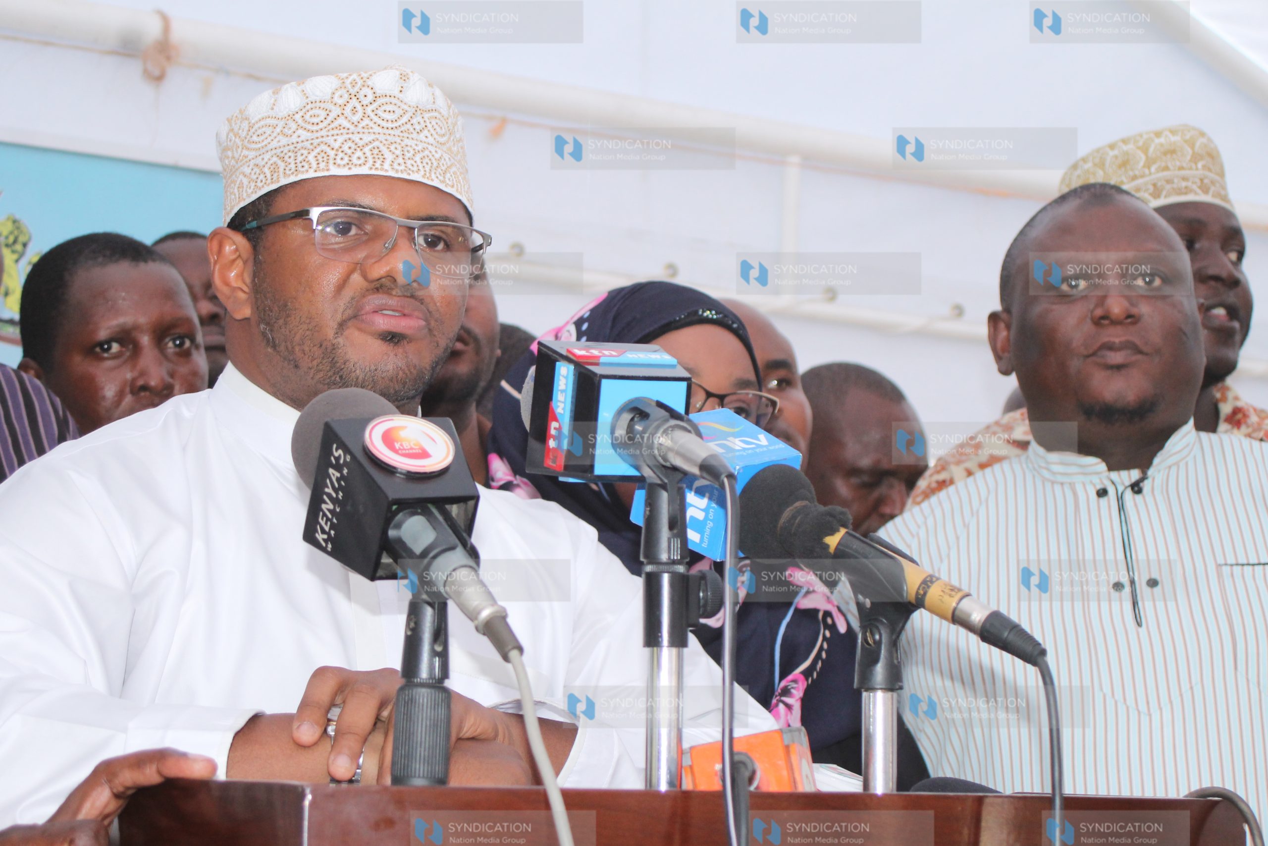 Hassan Omar (centre) addresses the press