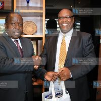 NMG CEO Stephen Gitagama presents a gift to Interior CS Fred Matiang'i