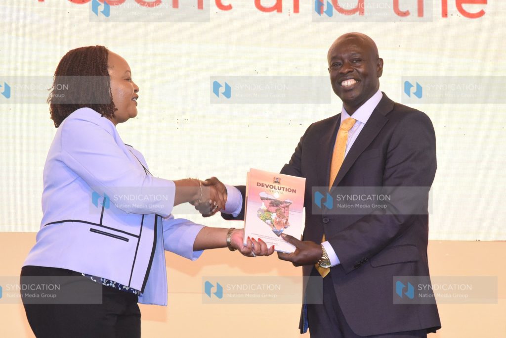 Deputy President Rigathi Gachagua receives a gift from Council of Governors Chairperson Ann Waiguru
