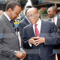 Deputy Prime Minister and Minister for Finance Uhuru Kenyatta confers with Family Bank Chairman Titus Muya