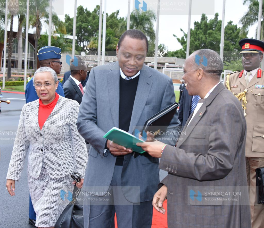 President Uhuru Kenyatta is briefed by the head of civil service Joseph Kinyua