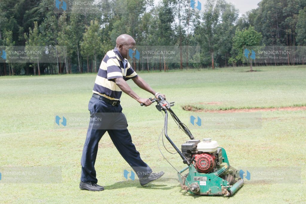 Ikolomani MP Dr. Boni Khalwale cutting green grass