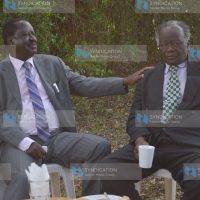 Raila Odinga (left) consoles John Khaminwa