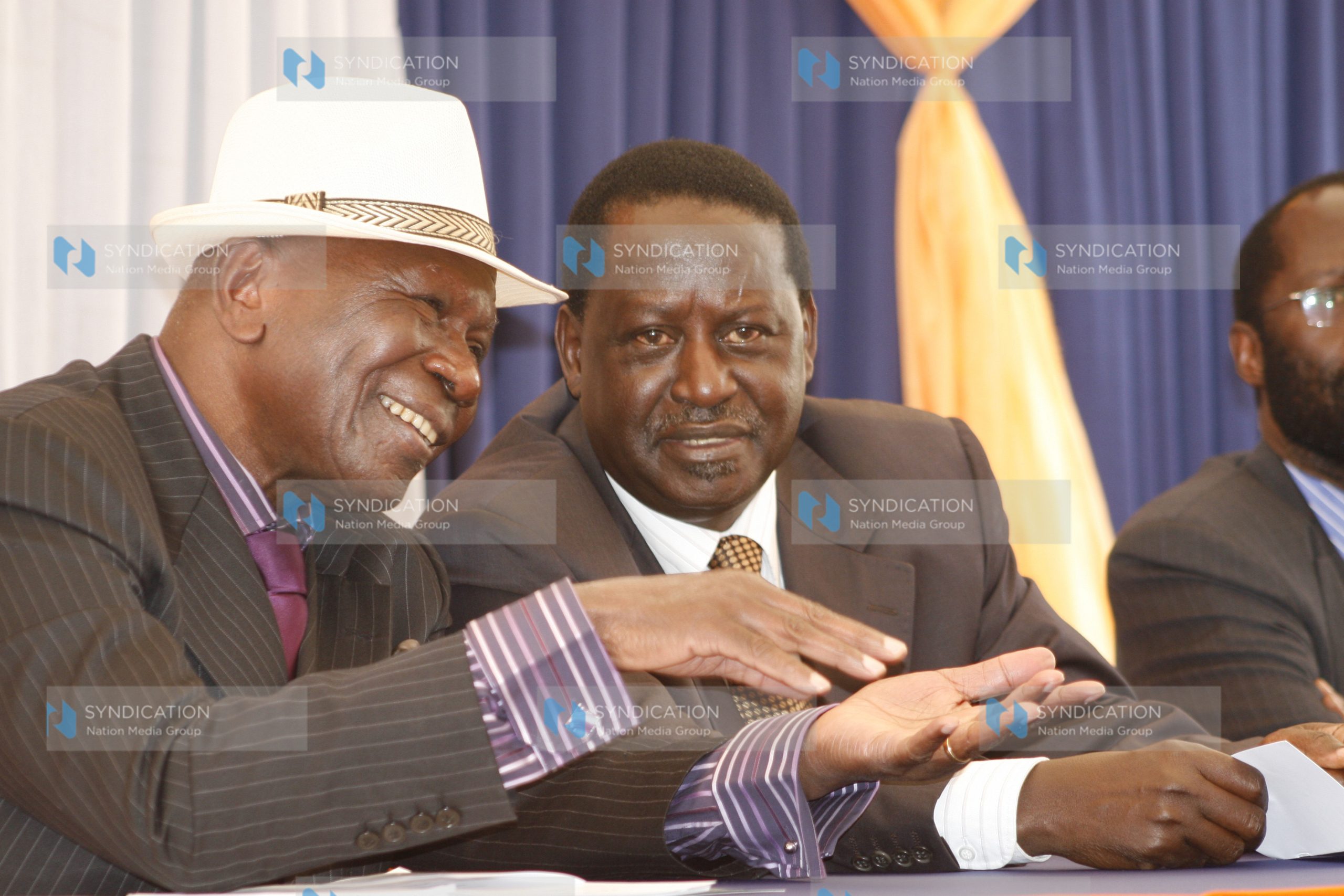 Prime Minister Raila Odinga confers with former Vice President Moody Awori