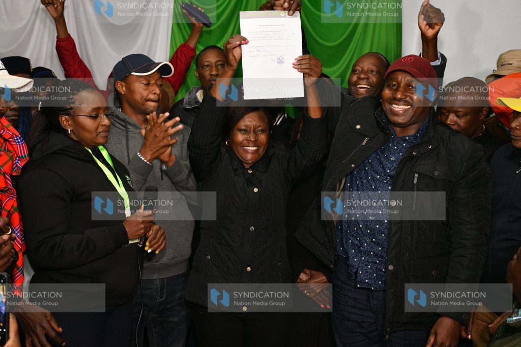 Embu governor-elect Cecily Mbarire holds up her certificate after being declared winner in the gubernatorial race