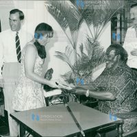 President Mzee Jomo Kenyatta presents the "President's Award booklet" to Miss Janis Joy Dunstan, of Australia