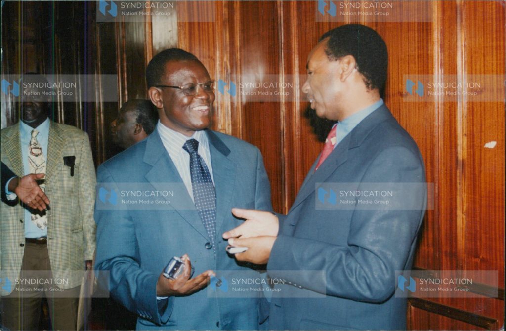 Justice and Constitutional Affairs minister Kiraitu Murungi chats with KANU MP Henry Kosgey