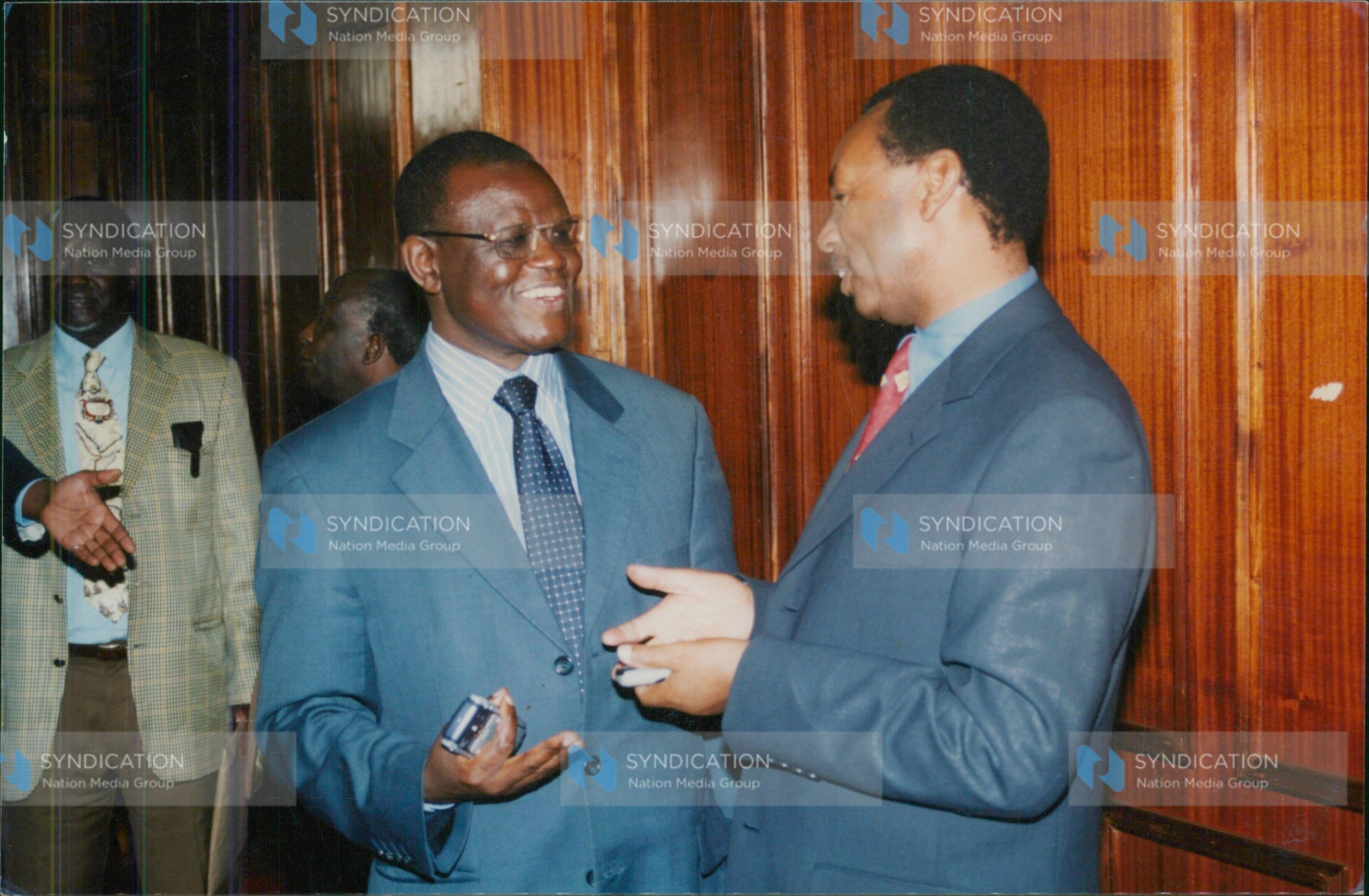 Justice and Constitutional Affairs minister Kiraitu Murungi chats with KANU MP Henry Kosgey