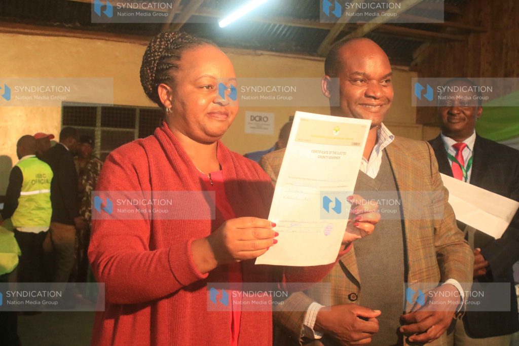 Anne Waiguru displays her certificate