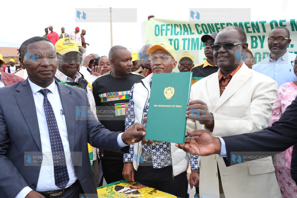 Kiraitu Murungi (right) displays the Timau Municipality charter