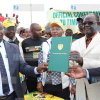 Kiraitu Murungi (right) displays the Timau Municipality charter