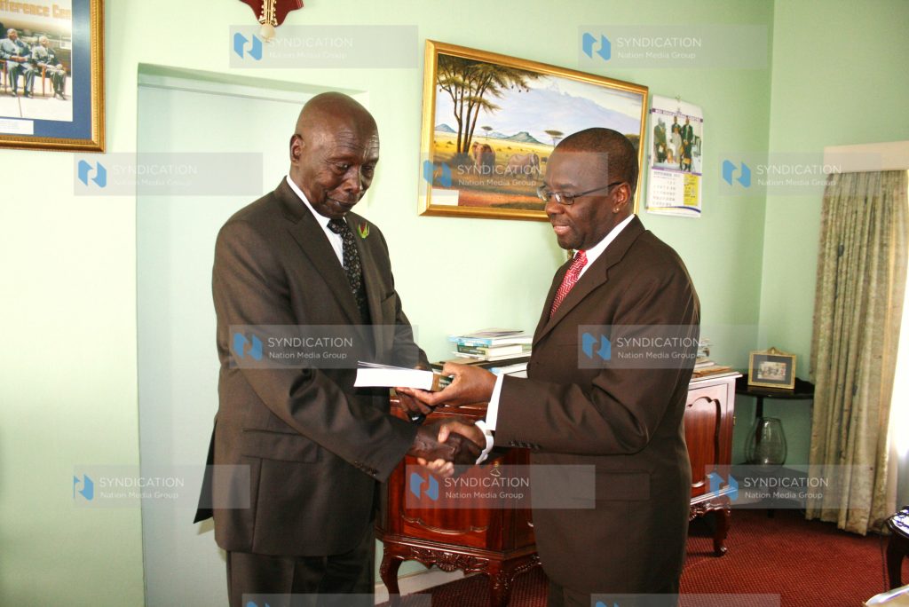 Former President Daniel Arap Moi receives a book titled Constitution-making