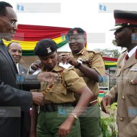 Minister for Internal Security Prof. George Saitoti decorates Senior Superintendent of Police Margaret Karanja from Chief Inspector