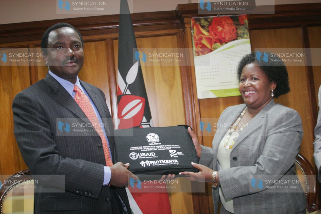 Vice President Kalonzo Musyoka, receives a gift from Naomi Wagereka