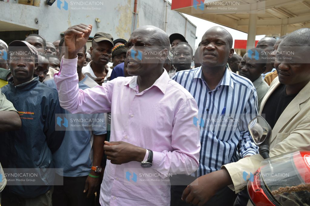 Kakamega Senator Dr. Boni Khalwale is surrounded by residents and town cleaners