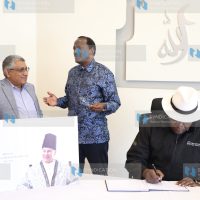 Eugene Wamalwa as he signs a condolence book