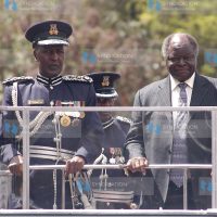President Mwai Kibaki chats with police Commissioner Maj Gen Hussein Ali