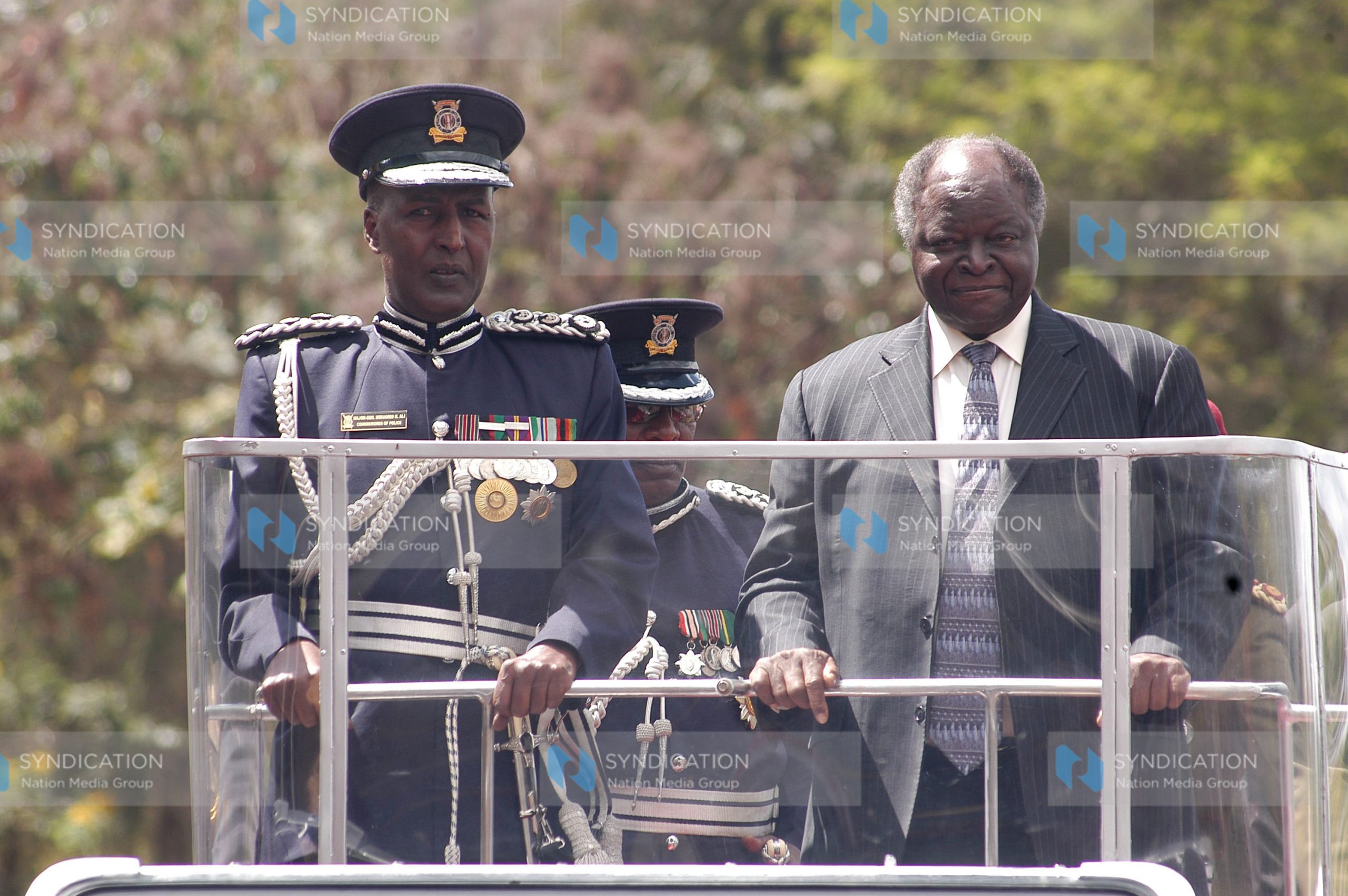 President Mwai Kibaki chats with police Commissioner Maj Gen Hussein Ali